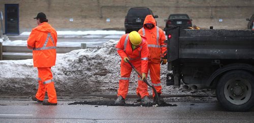 PHIL HOSSACK / WINNIPEG FREE PRESS - A city crew patches potholes along Wall street Monday. . .....See Aldo Santin story.  ....January 23, 2017