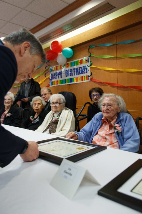 MIKE DEAL / WINNIPEG FREE PRESS
Marjorie Shatsky, 101, receives a certificate from member of parliament Terry Duguid during the Centenarian Celebration at the Saul & Claribel Simkin Centre where ten women will be celebrated for their birthdays, all of them at least 100 years old.
170123 - Monday, January 23, 2017.