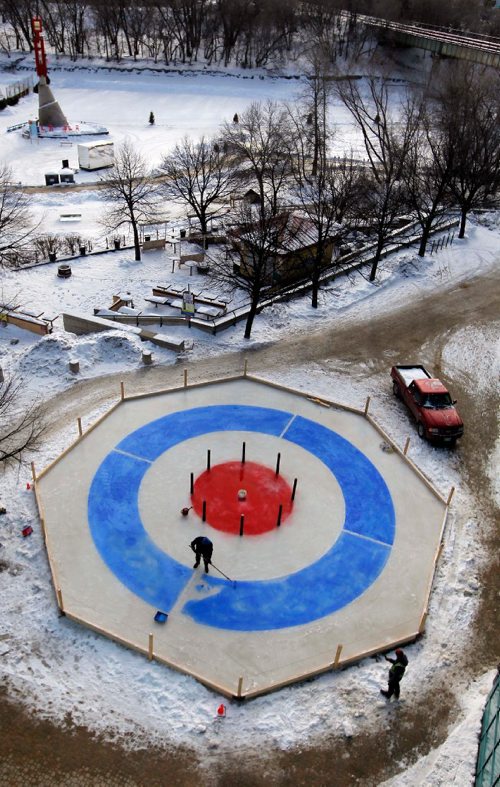BORIS MINKEVICH / WINNIPEG FREE PRESS
Visual artist James Culleton, on rink, was brought in to paint the lines on this 16 meter ice installation called "Crokicurl" at The Forks. On the bottom right is The Forks manager of special projects Dave Pancoe. JAN. 25, 2017