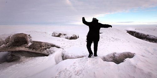 PHIL HOSSACK / WINNIPEG FREE PRESS -  A Winnipeg Beach resident balances carefully on the Windblown ice ridges pile up along the shore at Winnipeg Beach Provincial Park.  ....January 24, 2017