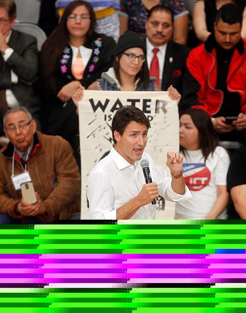 PHIL HOSSACK / WINNIPEG FREE PRESS -  Prime Minister Justin Trudeau debates hecklers in the Town Hall crowd at the University of Winnipeg Thursday as people seated behind him unfurl banners. See story.  ....January 26, 2017