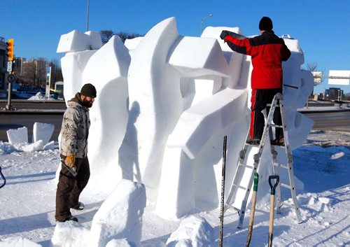 BORIS MINKEVICH / WINNIPEG FREE PRESS
Snow sculpture called "The Musicians" is being carved by Gary Tessier, right on ladder, with the assistance from his son André Vrignon-Tessier, left, at the corner of St. Mary's road and Goulet/Marion. JAN. 27, 2017