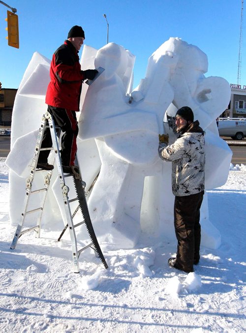 BORIS MINKEVICH / WINNIPEG FREE PRESS
Snow sculpture called "The Musicians" is being carved by Gary Tessier, left on ladder,  with the assistance from his son André Vrignon-Tessier, right,  at the corner of St. Mary's road and Goulet/Marion. JAN. 27, 2017