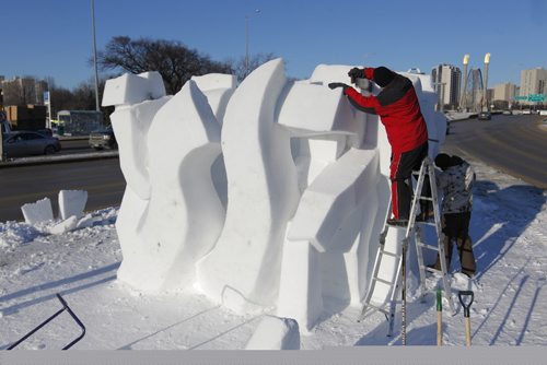 BORIS MINKEVICH / WINNIPEG FREE PRESS
Snow sculpture called "The Musicians" is being carved by Gary Tessier, in red on ladder,  with the assistance from his son André Vrignon-Tessier, right on ground behind, at the corner of St. Mary's road and Goulet/Marion. JAN. 27, 2017