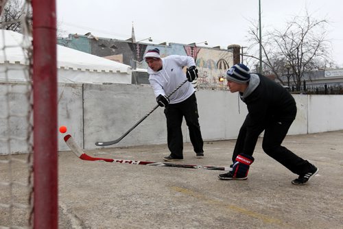 RUTH BONNEVILLE / WINNIPEG FREE PRESS

Justin Maeren (left) takes a shot into the net past Tyler Kee during a practice round of street hockey just before the start of the 3rd annual Village Winter Classic street hockey festival on Stradbook Ave. Saturday.  Stradbrook Ave. is closed to traffic until after 8pm this evening.  
Standup photo 


 Jan 28, 2017