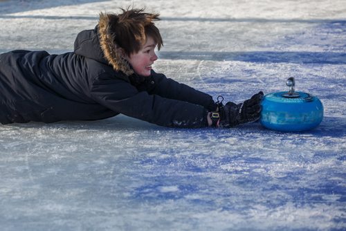 MIKE DEAL / WINNIPEG FREE PRESS
Felix Salkeld, 9, throws a curling rock while playing Croki-curl with his family at The Forks Sunday afternoon.
For 49.8 piece on Crokinole.
170129 - Sunday, January 29, 2017.
