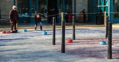 MIKE DEAL / WINNIPEG FREE PRESS
Lorene Giasson throws a curling rock while playing Croki-curl with her friend Rosa Conrad (left) at The Forks Sunday afternoon.
For 49.8 piece on Crokinole.
170129 - Sunday, January 29, 2017.