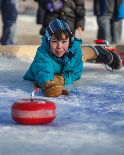 MIKE DEAL / WINNIPEG FREE PRESS
Ollie Salkeld, 8, throws a curling rock while playing Croki-curl with his family at The Forks Sunday afternoon.
For 49.8 piece on Crokinole.
170129 - Sunday, January 29, 2017.