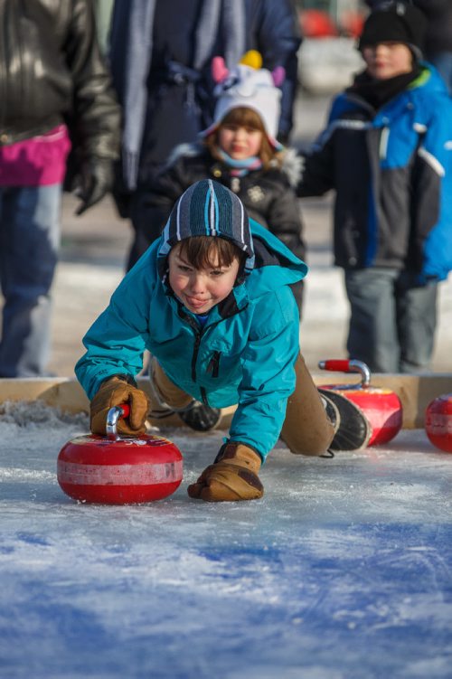 MIKE DEAL / WINNIPEG FREE PRESS
Ollie Salkeld, 8, throws a curling rock while playing Croki-curl with his family at The Forks Sunday afternoon.
For 49.8 piece on Crokinole.
170129 - Sunday, January 29, 2017.