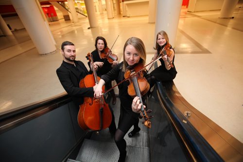 RUTH BONNEVILLE / WINNIPEG FREE PRESS

 Members of the Winnipeg Symphony Orchestra pose for photo in the downtown Hudson Bay basement for an advancer for the WSO concert at The Bay.
Names from left -   Sean Taubner, cello, Elise Lavallée, viola,   Kristina Bauch, violin front and centre (sleeves)  and Meredith McCallum, violin (no sleeves)        
           
           
Jan 27, 2017