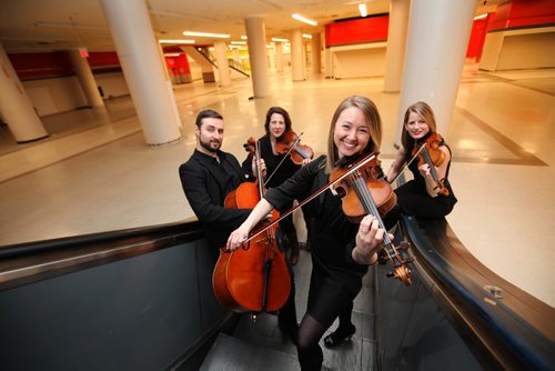 RUTH BONNEVILLE / WINNIPEG FREE PRESS

 Members of the Winnipeg Symphony Orchestra pose for photo in the downtown Hudson Bay basement for an advancer for the WSO concert at The Bay.
Names from left -   Sean Taubner, cello, Elise Lavallée, viola,   Kristina Bauch, violin front and centre (sleeves)  and Meredith McCallum, violin (no sleeves)        
           
           
Jan 27, 2017