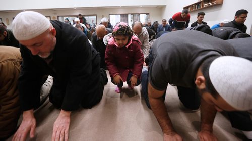 JOHN WOODS / WINNIPEG FREE PRESS
A girl copies the men as they pray and about 400 people gathered for a special prayer service for victims of the Quebec mosque shooting at the Waverley Grand Mosque Monday, January 30, 2017.