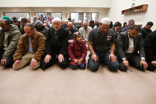 JOHN WOODS / WINNIPEG FREE PRESS
A girl watches as men pray and about 400 people gathered for a special prayer service for victims of the Quebec mosque shooting at the Waverley Grand Mosque Monday, January 30, 2017.