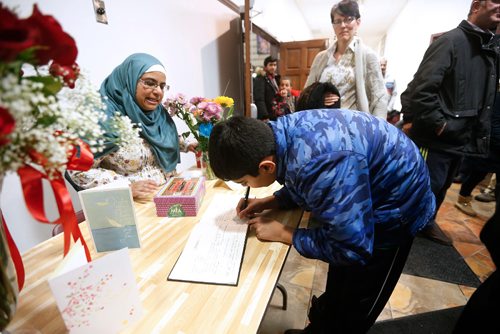JOHN WOODS / WINNIPEG FREE PRESS
People sign a book of condolences as about 400 people gathered for a special prayer service for victims of the Quebec mosque shooting at the Waverley Grand Mosque Monday, January 30, 2017.