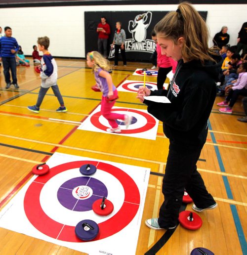BORIS MINKEVICH / WINNIPEG FREE PRESS
The Egg Farmers Rocks & Rings program presented by Curling Canada ran their first official Rocks & Rings tournament in Winnipeg February 1, 2017. Four area schools came together to compete against each other for a fun filled exciting day of curling at École Marie-Anne-Gaboury in St. Vital. École Marie-Anne-Gaboury grade 8 student Clara Gibbons,right, helps keep score for the event. Feb. 1, 2017