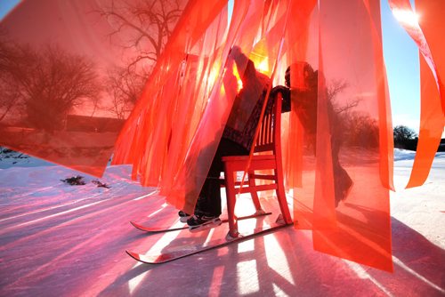RUTH BONNEVILLE / WINNIPEG FREE PRESS

Ethan Offman (9yrs) pushes his little sister Avelyn (5yrs) on a chair with skis through - Open Border warming hut, a wall made out of  translucent strips of orange plastic strips hanging like a wall across the River Trail along the Assiniboine River.  
atelier ARI's open border installation in canada defies political tensions
responding to the tensed political climate spreading across the world, rotterdam based atelier ARI unveils a brightly red installation set across the assiniboine river in winnipeg, canada. stretching almost four meters in height, the wall titled open border creates a striking contrast against the white snowy landscape and the sinuous ice skating trail through which it cuts perpendicularly.
See Jen Zoratti's story.  
Feb 03,, 2017
