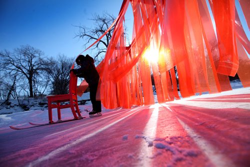 RUTH BONNEVILLE / WINNIPEG FREE PRESS

Ethan Offman (9yrs) pushes chair with skis through - Open Border warming hut, a wall made out of  translucent strips of orange plastic strips hanging like a wall across the River Trail along the Assiniboine River.  
atelier ARI's open border installation in canada defies political tensions
responding to the tensed political climate spreading across the world, rotterdam based atelier ARI unveils a brightly red installation set across the assiniboine river in winnipeg, canada. stretching almost four meters in height, the wall titled open border creates a striking contrast against the white snowy landscape and the sinuous ice skating trail through which it cuts perpendicularly.
See Jen Zoratti's story.  
Feb 03,, 2017
