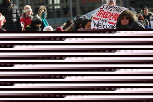 RUTH BONNEVILLE / WINNIPEG FREE PRESS

Protestors hold signs  at ralliy at 201 Portage  to call on Mayor Brian Bowman to make Winnipeg a sanctuary city for undocumented migrants Friday. 

Feb 03,, 2017
