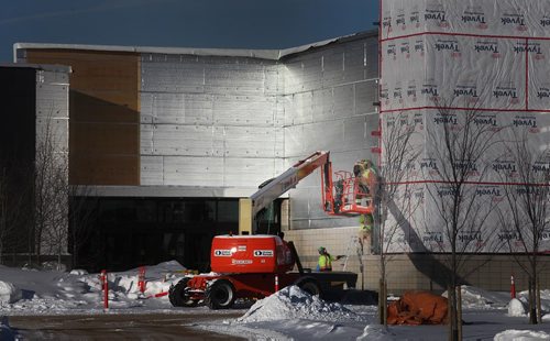 PHIL HOSSACK / WINNIPEG FREE PRESS  -  Construction workers work in the glare from aluminum covered insulation on a mall on the NW corner of Kenaston and Sterling Lyon Tuesday in the "Season's' residential, office, commercial development. Murray McNeil's story.   - February 7, 2017