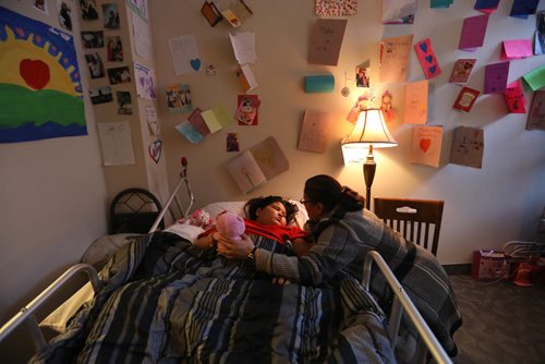 RUTH BONNEVILLE / WINNIPEG FREE PRESS

Jordin Bailey's grade one teacher from Norway House, Linda Fariss, spents some quiet moments at her bedside in Winnipeg Tuesday.   The eight-year-old girl from Norway House with terminal brain cancer whose last wish from the organization that grants them wasn't to go to Disneyland. Instead little Jordin wanted to create a park and playground at the end of her street for other kids to enjoy after she's gone. Nearly $60,000 has already been raised by the Norway House community and the Manitoba RCMP.

(Mother Lisa Kematch and stepfather Thomas Balfour will be there)
FOR Sinclair Wednesday column

  Feb 07,, 2017
