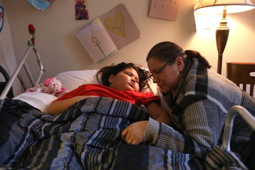 RUTH BONNEVILLE / WINNIPEG FREE PRESS

Jordin Bailey's grade one teacher from Norway House, Linda Fariss, spents some quiet moments at her bedside in Winnipeg Tuesday.   The eight-year-old girl from Norway House with terminal brain cancer whose last wish from the organization that grants them wasn't to go to Disneyland. Instead little Jordin wanted to create a park and playground at the end of her street for other kids to enjoy after she's gone. Nearly $60,000 has already been raised by the Norway House community and the Manitoba RCMP.

(Mother Lisa Kematch and stepfather Thomas Balfour will be there)
FOR Sinclair Wednesday column

  Feb 07,, 2017
