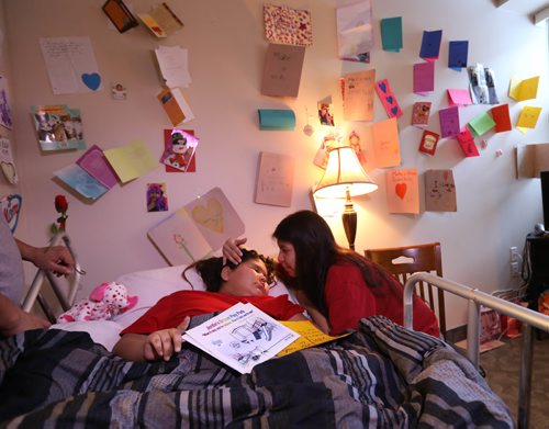 RUTH BONNEVILLE / WINNIPEG FREE PRESS

Jordin Bailey holds onto a poster of an artist rendering of a playground to be built in Norway House in her name as her mom, Lisa Kematch, comforts her at her bedside in WinnipegTuesday.  The eight-year-old girl from Norway House with terminal brain cancer whose last wish from the organization that grants them wasn't to go to Disneyland. Instead little Jordin wanted to create a park and playground at the end of her street for other kids to enjoy after she's gone. Nearly $60,000 has already been raised by the Norway House community and the Manitoba RCMP.

(Mother Lisa Kematch and stepfather Thomas Balfour will be there)
FOR Sinclair Wednesday column

  Feb 07,, 2017
