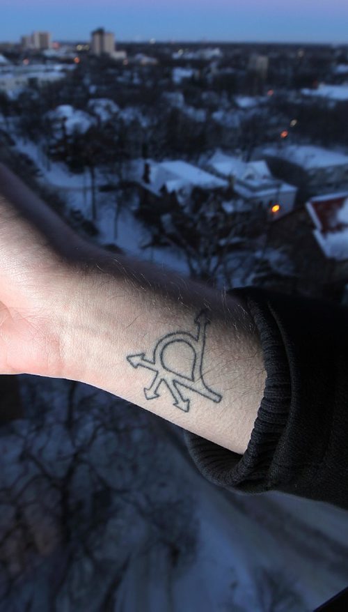 PHIL HOSSACK / WINNIPEG FREE PRESS  -  Robert Keizer shows off his "confusion corenr" tattoo overlooking the "Village". He's is a young, adult resident of Osborne Village, and chose the area for its walkability.  He poses on his balcony overlooking the "Village neighborhood he calls home. Kelly Taylor story. - February 7, 2017