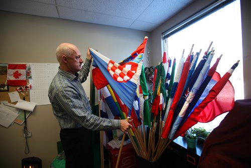 RUTH BONNEVILLE / WINNIPEG FREE PRESS

SATURDAY SPEICAL: STEINBACH GROWTH
Richard Harder, program director of the Eastman Immigration Services in Steinbach talks about the population explosion and the multi-cultural element with reporter.  
Harder with flags from hundreds of countries now being represented in their growing city and showcased with flags representing their home country during Steinbach's annual culture days.  

  Feb 07,, 2017
