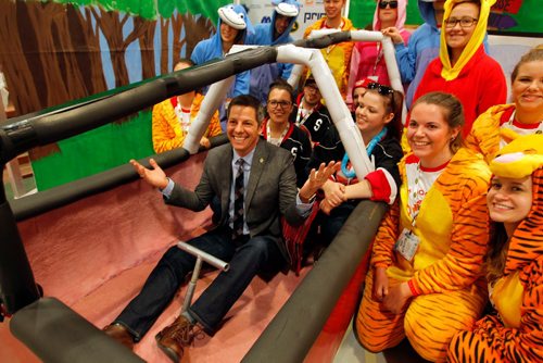 BORIS MINKEVICH / WINNIPEG FREE PRESS
Winnipeg Mayor Brian Bowman tries sitting in the cockpit of one of the entries from the University of Manitoba. It has a Winnie the Poo theme. He was there to give some informal greetings to the teams from all across the country.

info from website: The Great Northern Concrete Toboggan Race (GNCTR) is the largest student run engineering competition in Canada. Dating back to 1975, this adaptation of the American Concrete Canoe Race brings together over 450+ engineering students from universities and technical institutions across Canada. These students will be given the opportunity to apply and develop their skills in design, technical writing, networking, and management.

In February of 2017, Winnipeg will be carrying on the GNCTR tradition of teamwork, sportsmanship, school spirit, and innovation.

About the Toboggans
Competitors will be asked to design and build a toboggan which can safely carry five passengers. All toboggans must consist of an entirely concrete running surface, a structural frame, a breaking system, and a functional steering system all while weighing less than 350lbs. Teams will be judged on a number on categories including concrete mix design, frame design, steering, breaking, a technical report, race day speed, and school spirit. Teams will not be allowed to compete if their toboggans do not meet the safety and technical guidelines. Feb. 10, 2017