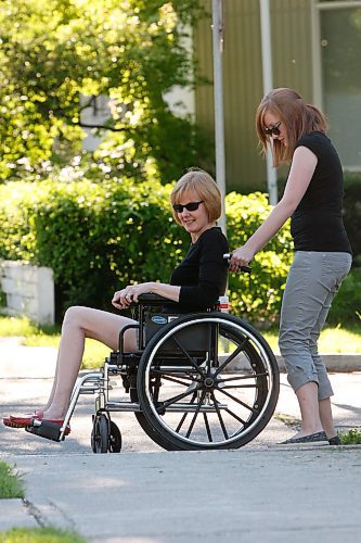 BORIS MINKEVICH / WINNIPEG FREE PRESS 080915 Lindor Reynolds gets pushed along in a wheelchair by her daughter Katie.
