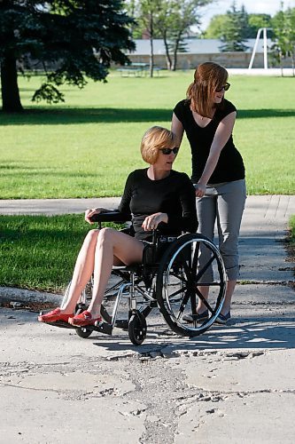 BORIS MINKEVICH / WINNIPEG FREE PRESS  080915 Lindor Reynolds gets pushed along in a wheelchair by her daughter Katie.