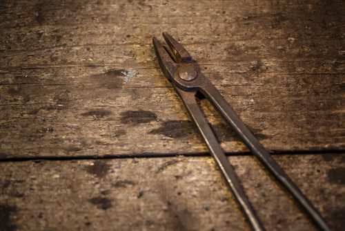 MIKE DEAL / WINNIPEG FREE PRESS
Blacksmith Matt Jenkins owner of Cloverdale Forge.
Long armed tongs sits on the workbench.
170131 - Tuesday, January 31, 2017.