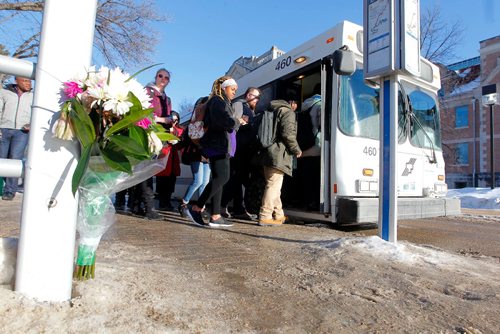 BORIS MINKEVICH / WINNIPEG FREE PRESS
People get on the bus where flowers were in memorial of Winnipeg Transit driver Irvine Jubal Fraser, who was was murdered. At U of M. Feb. 15, 2017