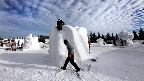 PHIL HOSSACK / WINNIPEG FREE PRESS  -   Venezuelan Sculptors Frederick Pimentel (top) and Miguel Albinowork to finish their piece before the Festival du Voyageur site at Whittier Park  open's tomorrow (Friday). Their piece is part of an International Snow Sculpting Symposium exhibition at the Festival. - February 16, 2017