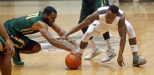 PHIL HOSSACK / WINNIPEG FREE PRESS  - Regina Cougar #11Brian Ofori and Manitoba Bison's #5 Ilarion Bonhomme scramble on the floor for possession Thursday evening at the Investor's Group Athletic Centre. See Scott Billeck's story.. - February 16, 2017