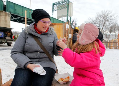 BORIS MINKEVICH / WINNIPEG FREE PRESS
From left, Meghan Robert and her daughter Isabel Robert,6, enjoy some yummy breakfast at The Fork Red River Mutual trail where The Rendez-vous on Ice event took place. Le Festival du Voyageur kicks off this weekend. Feb. 17, 2017