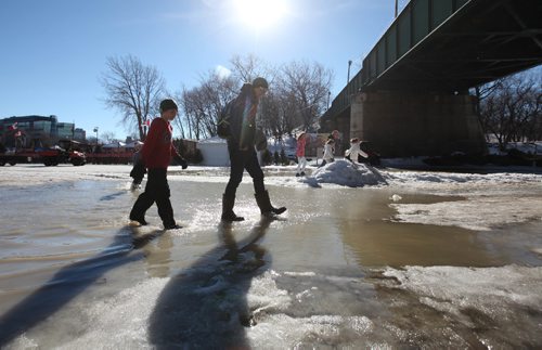 RUTH BONNEVILLE / WINNIPEG FREE PRESS

Ben Grahn and his dad Greg (younger brother, Jude,behind  them) walk through puddles of standing water on the River Trail at the Forks Saturday.  Official's say it's still  safe to walk on but skating in most spots is too slushy. The Forks plan to put up signs to close the trail due to sloppy surface and warm weather conditions later today. 
 
Feb 18, 2017

