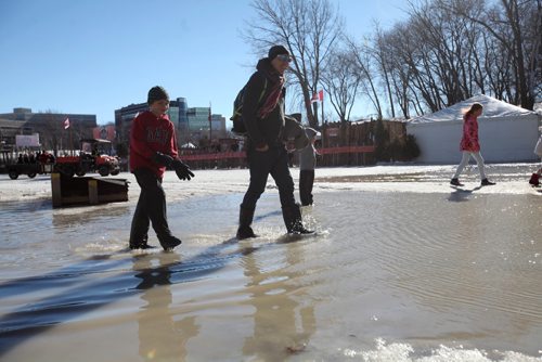 RUTH BONNEVILLE / WINNIPEG FREE PRESS

Ben Grahn and his dad Greg (younger brother, Jude,behind  them) walk through puddles of standing water on the River Trail at the Forks Saturday.  Official's say it's still  safe to walk on but skating in most spots is too slushy. The Forks plan to put up signs to close the trail due to sloppy surface and warm weather conditions later today. 
 
Feb 18, 2017
