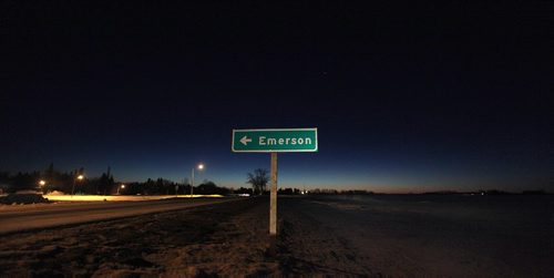 PHIL HOSSACK / WINNIPEG FREE PRESS  -   Saturday morning dawns along the international border (left of the sign) at Emerson Mb. with no Somali or other refugees making the trek across snow covered fields. See Mike MacIntyre story- February 16, 2017