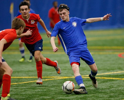 JOHN WOODS / WINNIPEG FREE PRESS
Dakota United's Zachary Bares (blue) moves in for the shot as Bonnie Vital's Ethan Winzinowich and Jaron Wiebe defend during their match at the Golden Boy Youth Indoor Soccer Tournament Winnipeg Soccer Federation North soccer complex Sunday, January 19, 2017.