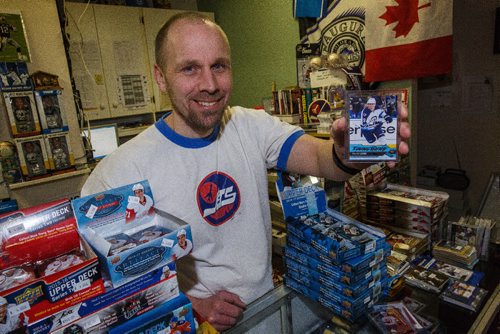 MIKE DEAL / WINNIPEG FREE PRESS
Mike Bergmann owner of Lower Level Sports Cards on Henderson Hwy has the newly released Patrik Laine Young Guns rookie hockey card.
170221 - Tuesday, February 21, 2017.