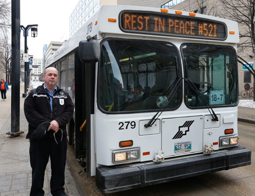 WAYNE GLOWACKI / WINNIPEG FREE PRESS
A Winnipeg Transit driver on Graham Ave. Tuesday observed a moment of silence on Tuesday at 1 P.M.in honour of murdered fellow driver Irvine Jubal Fraser. Feb. 21  2017