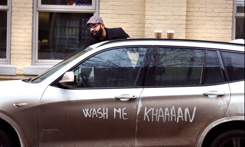.WAYNE GLOWACKI / WINNIPEG FREE PRESS

 Obby Khan, a former Winnipeg Blue Bomber player and now restaurateur exits his car Tuesday with a friendly reminder written in the street grim by his restaurant manager.  The roads could by messy until Thursday when temperatures during the day fall below zero, possibly a good time for a car wash. Feb. 21  2017
