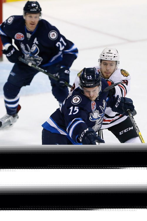 JOHN WOODS / WINNIPEG FREE PRESS
Manitoba Moose Scott Glennie (15) attempts to break lose of Rockford Ice Hogs' Tyler Motte (9) as Kevin Czuczman (27) looks on during first period AHL action in Winnipeg on Tuesday, February 21, 2017.