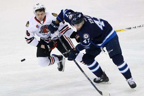 JOHN WOODS / WINNIPEG FREE PRESS
Manitoba Moose Brian Strait (47) checks Rockford Ice Hogs' Evan Mosey (26) during first period AHL action in Winnipeg on Tuesday, February 21, 2017.