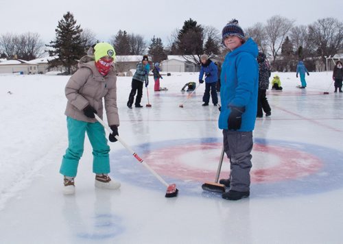 Canstar Community News Feb. 13, 2017 - Grade 4 students Ella Chmidt (left) and Samuel Kasdorf of Donwood School (400 Donwood Dr.) practiced skipping teams of their classmates leading up to the school's annual bonspiel on Feb. 14. Both said that they were new to curling, and enjoyed how competitive the sport can be. (SHELDON BIRNIE/CANSTAR/THE HERALD).