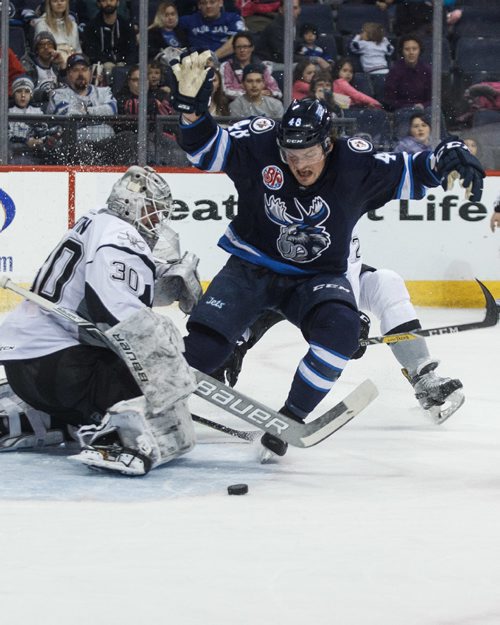 MIKE DEAL / WINNIPEG FREE PRESS
Manitoba Moose' Brendan Lemieux (48) tries to avoid hitting the hitting San Antonio Rampage' goaltender Spencer Martin (30) while he is checked from behind by Rampage' Mason Geertsen (2) in AHL season action at the MTS Centre Sunday afternoon. 
170226 - Sunday, February 26, 2017.