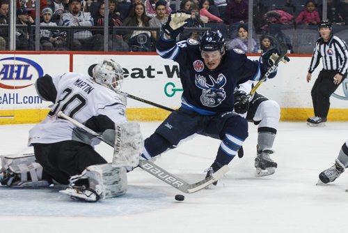 MIKE DEAL / WINNIPEG FREE PRESS
Manitoba Moose' Brendan Lemieux (48) tries to avoid hitting the hitting San Antonio Rampage' goaltender Spencer Martin (30) while he is checked from behind by Rampage' Mason Geertsen (2) in AHL season action at the MTS Centre Sunday afternoon. 
170226 - Sunday, February 26, 2017.