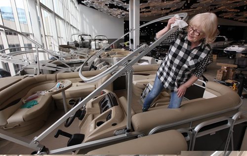 PHIL HOSSACK / WINNIPEG FREE PRESS  -  Donna Bartlett details a West Hawk Marina pontoon boat one of the many boats being set up for this week's Boat Show at the Convention Centre. See Willy's story.  - February 27, 2017