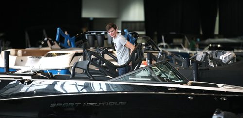 PHIL HOSSACK / WINNIPEG FREE PRESS  -  A worker inspects the interior of one of the many boats being set up for this week's Boat Show at the Convention Centre. See Willy's story.  - February 27, 2017